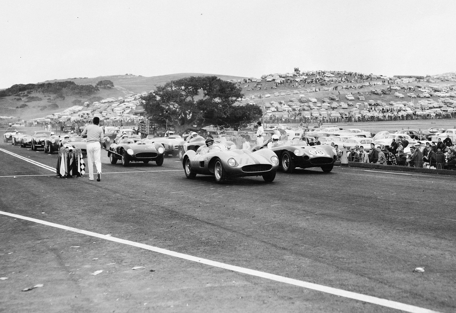 John Von Neumann (number 11 Ferrari TR) lines up next to Carroll Shelby (number 98 Maserati 450S) for Laguna Seca's debut race