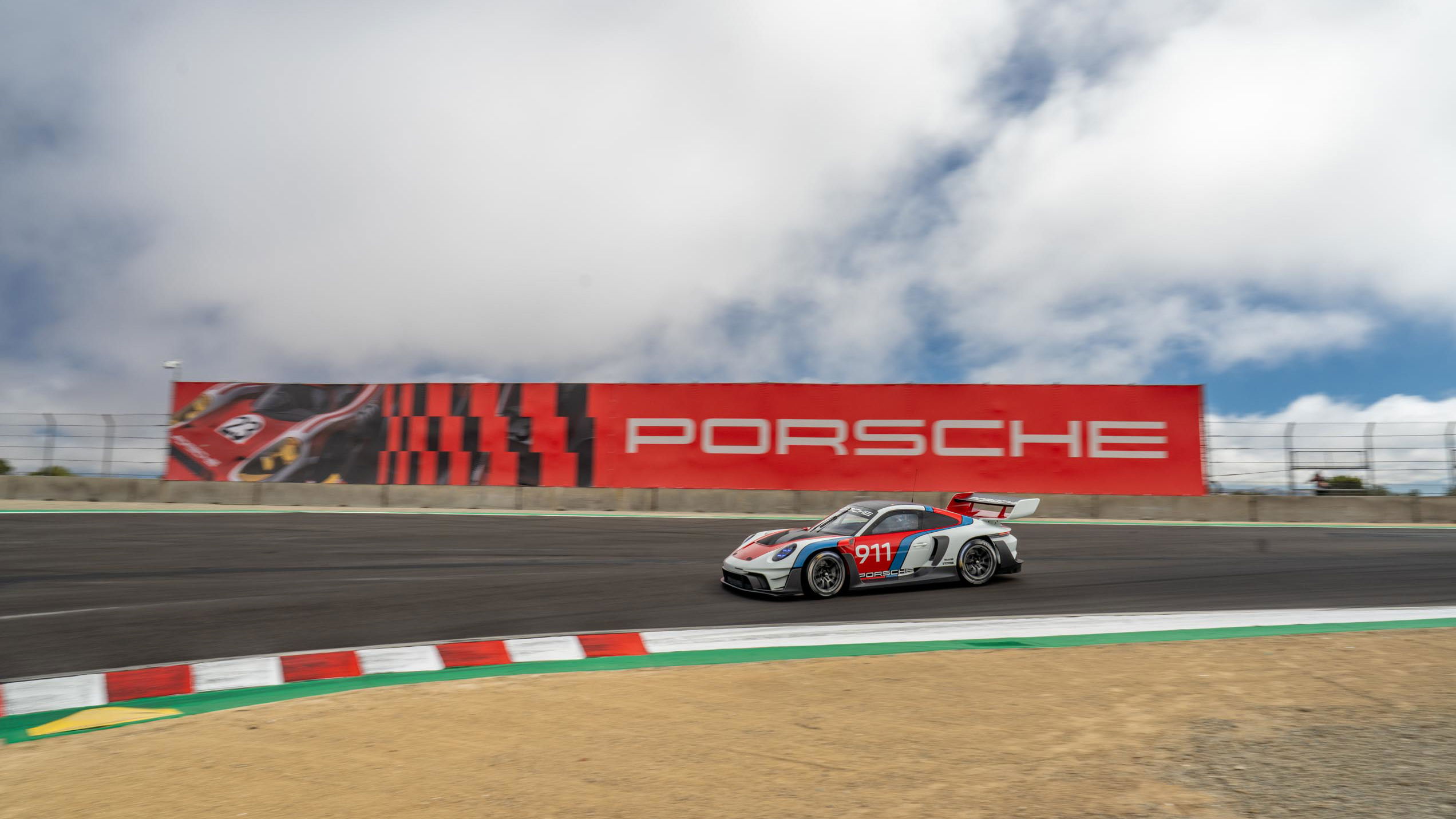 A Porsche 911 GT3 R rennsport enters the Corkscrew at Laguna Seca