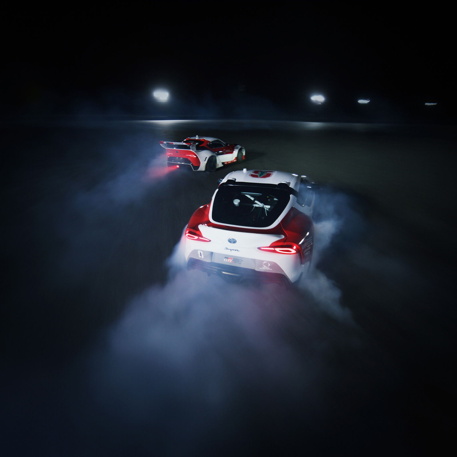 Two autonomous Toyota GR Supras drifting