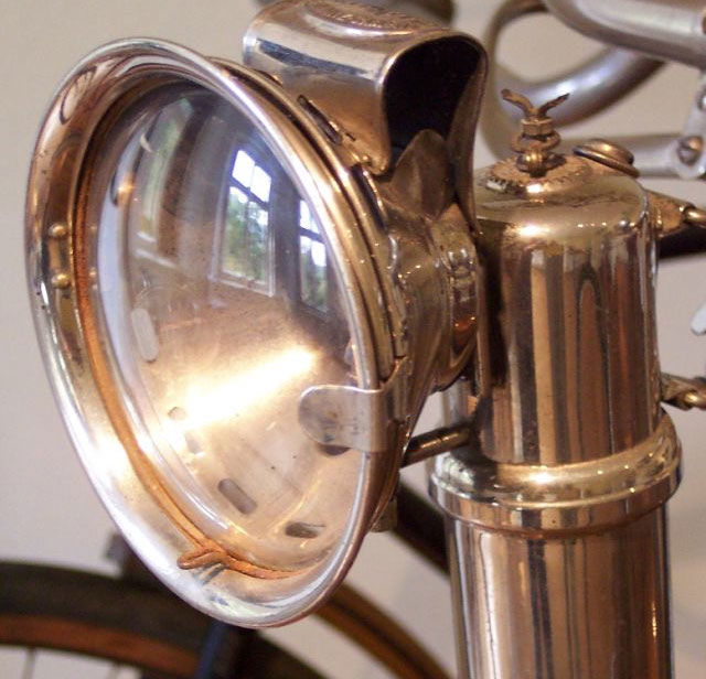 A carbide/acetylene lamp fitted to a bicycle. Via Wikimedia Commons.