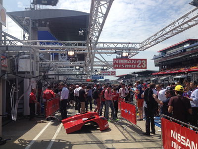 Thousands of fans with special passes get close to the cars for pics 