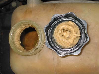 Known elegantly as 'mayo', this yellow gunk is formed as hot water and oil mix together due to a gasket leak, an instant giveaway for head gasket failure