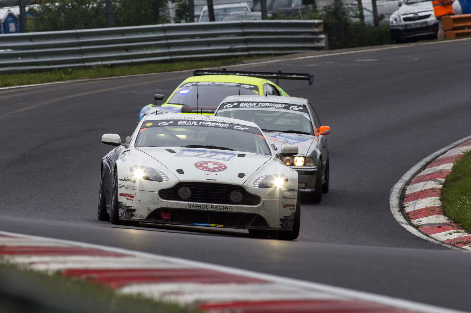 Yep, that really is an old E36 BMW sandwiched between an Aston Martin Vantage and an Audi R8