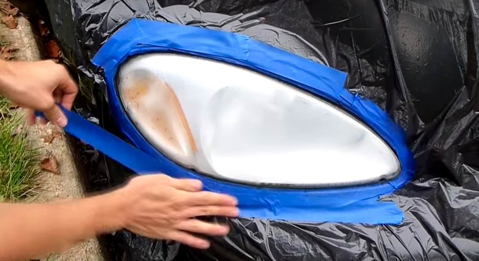 Carefully cut out a hole for your headlight and tape around it