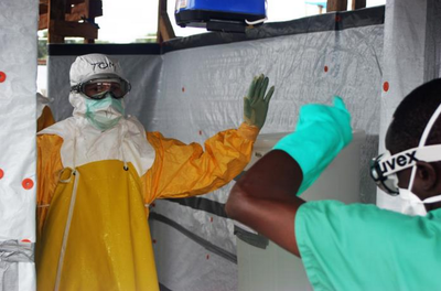 Medical workers go through a decontamination procedure in the Liberian capital, Monrovia. Image source: CDC