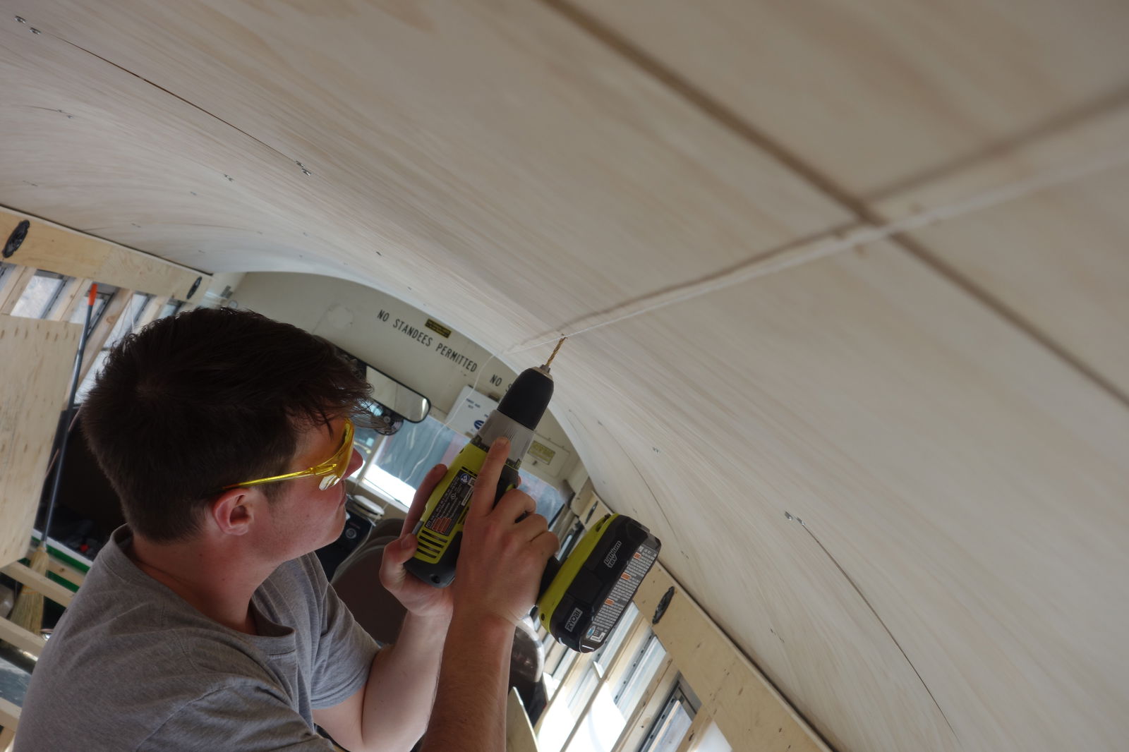 Plywood was secured to the roof of the bus.
