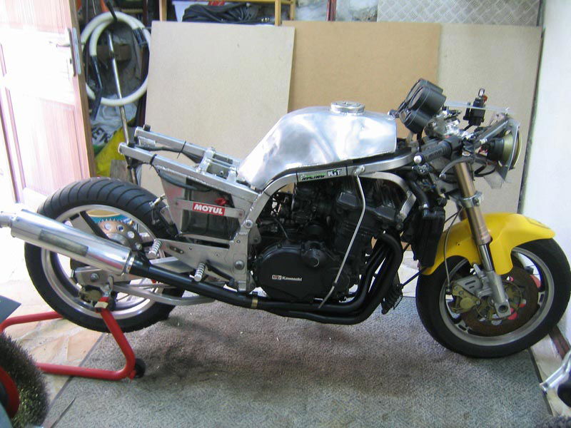 The exposed internals reveal the handmade alloy frame, aluminum fuel tank and the Kawasaki engine