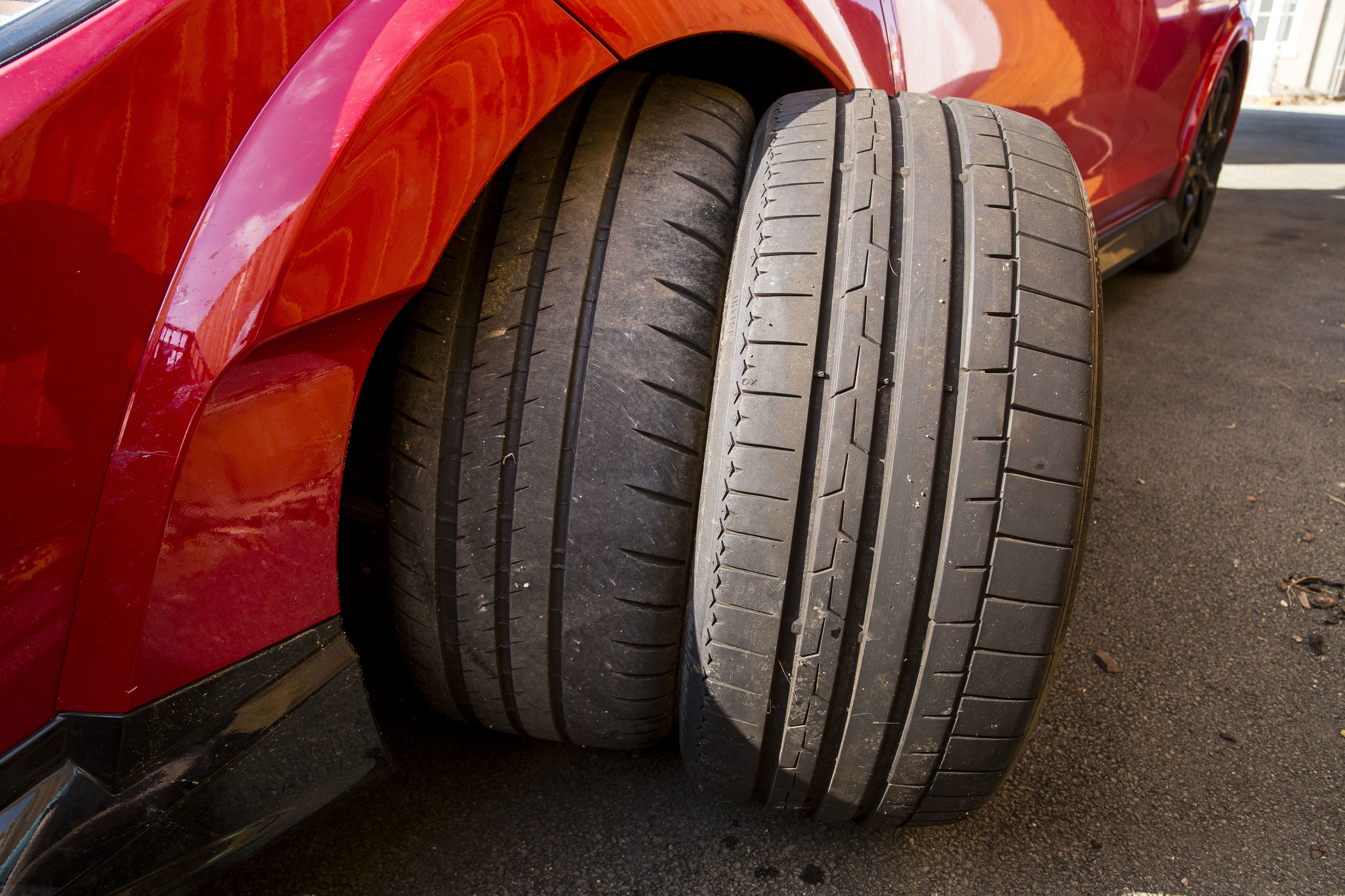 A side by side comparison of the new Michelins (left) and the stock Continentals (right) showing how much less tread the Michelins posses