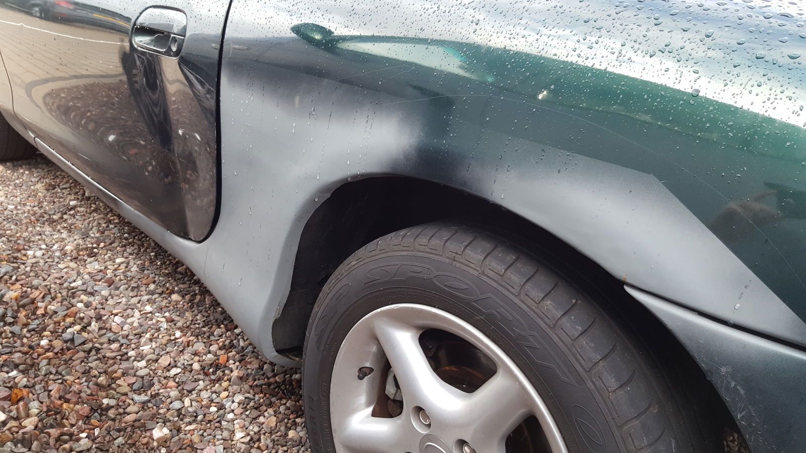 The newly repaired (and slightly skewed) sill and wheel arch ready for painting