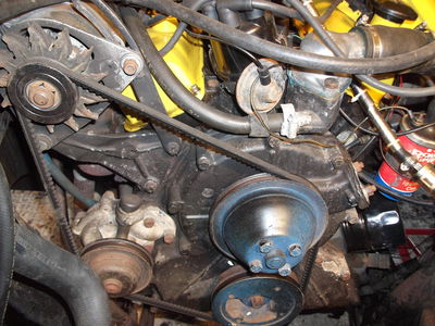 This pulley system on an old Reliant Scimitar shows an old-style exterior fan on the alternator (top left)