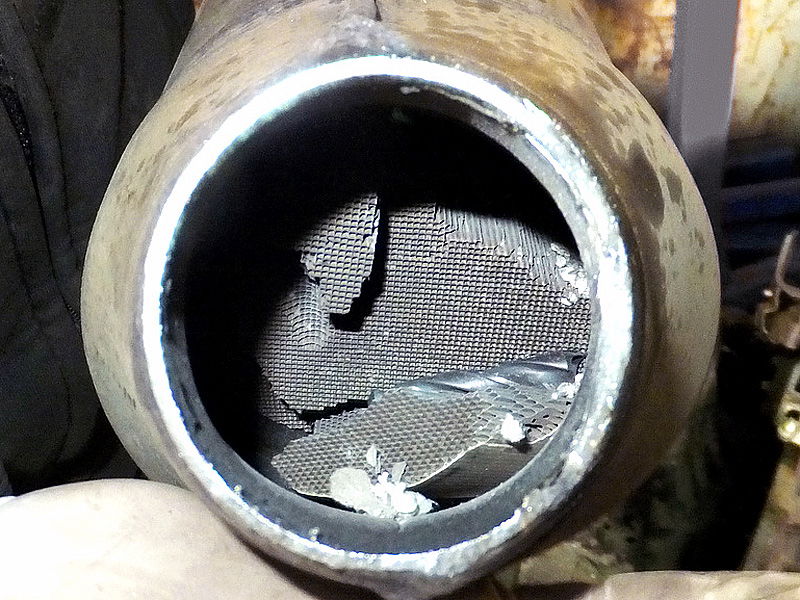 The honeycomb structure within has disintegrated due to extremely high temperatures created by unburnt fuel