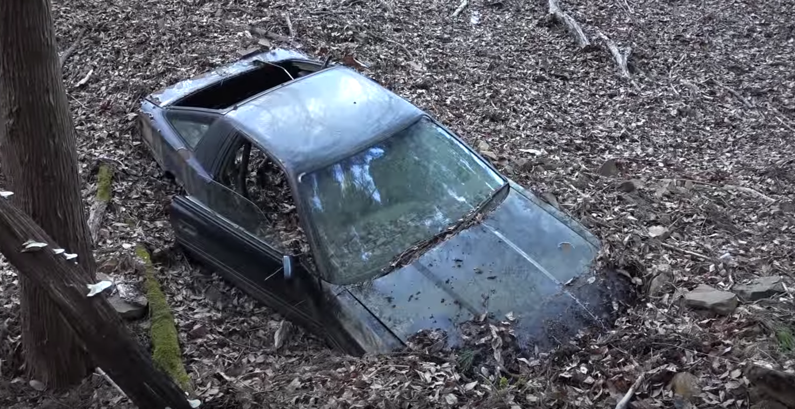 This 'Unrecoverable' Toyota Supra Lies Half Buried On The Side Of A Hill In Japan