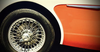 The contrast of red and white, the wire wheels, the curved skirt and the chromed strake just add up to something magnificent.