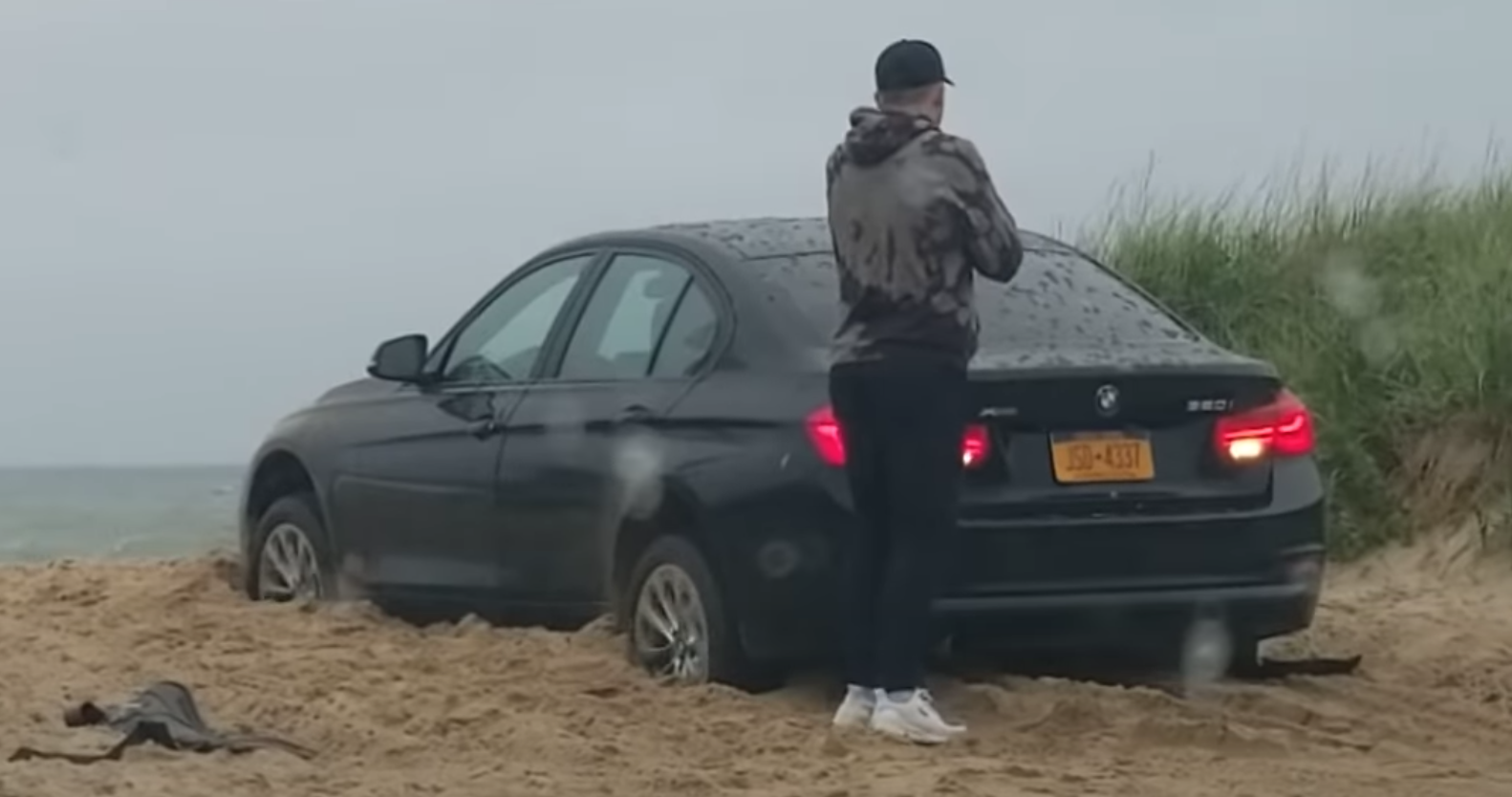 Man Leaves Beached BMW In Reverse Then Locks Himself Out
