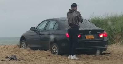 Man Leaves Beached BMW In Reverse Then Locks Himself Out